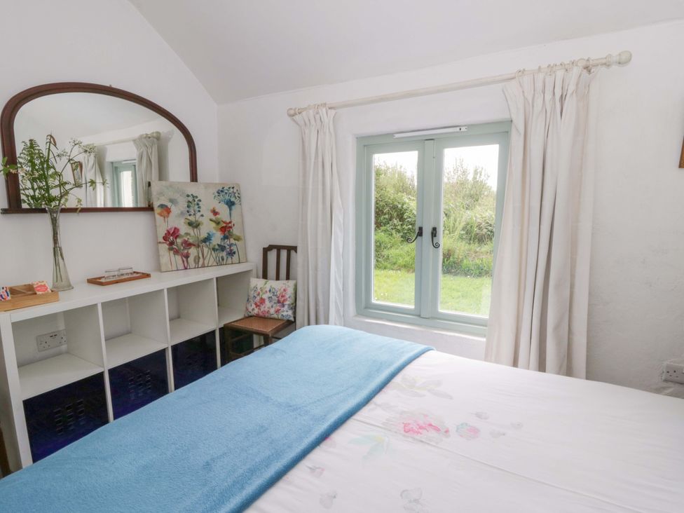 A bedroom with a bed and a window at Rhos Y Clegyrn Goodwick