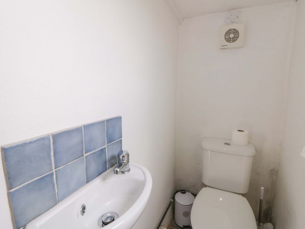 A bathroom with a sink and a toilet at Rhos Y Clegyrn Goodwick