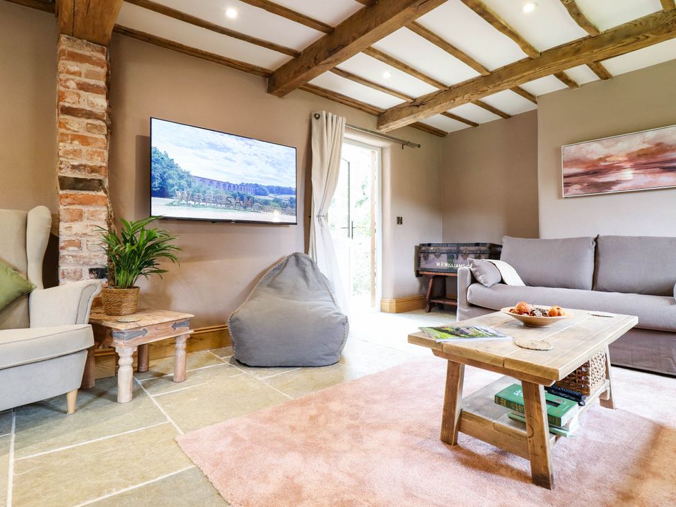 A living room with a sofa and television at Bridge Farm Pontyblew near Chirk