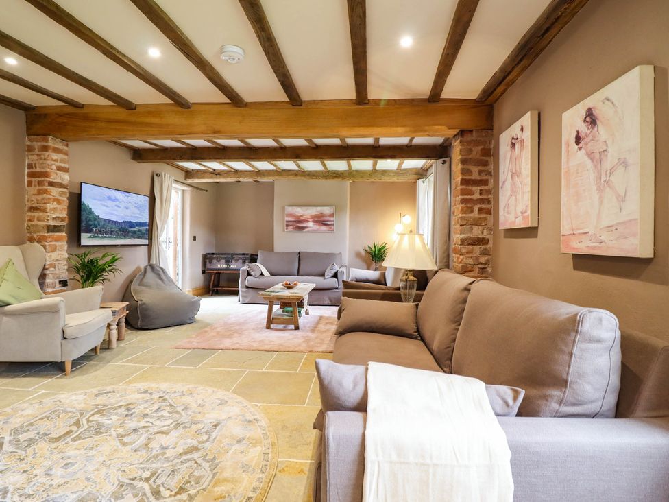 A living room with a sofa and television at Bridge Farm Pontyblew near Chirk