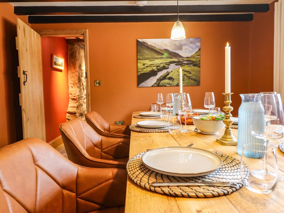 A dining room with a wooden table and chairs at Bridge Farm Pontyblew near Chirk