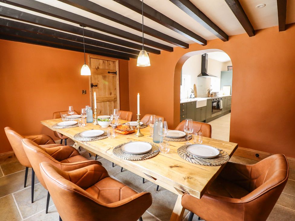 A dining room with a wooden table and chairs at Bridge Farm near Pontyblew Chirk