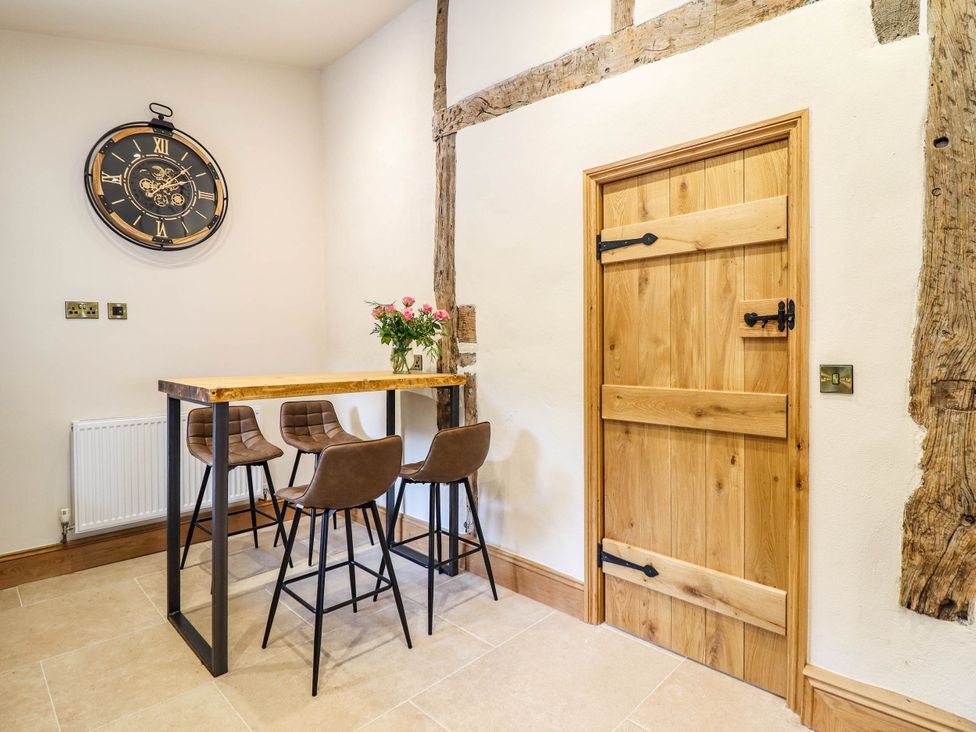 A dining room with a table and chairs at Bridge Farm Pontyblew near Chirk