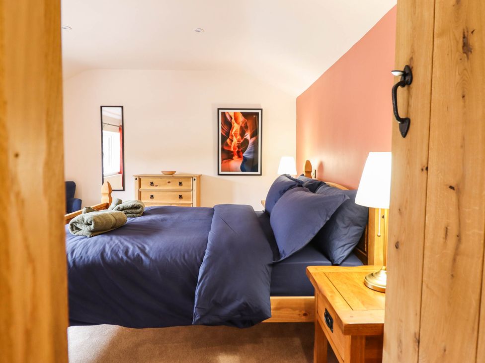 A bedroom with a bed and furniture at Bridge Farm in Pontyblew near Chirk