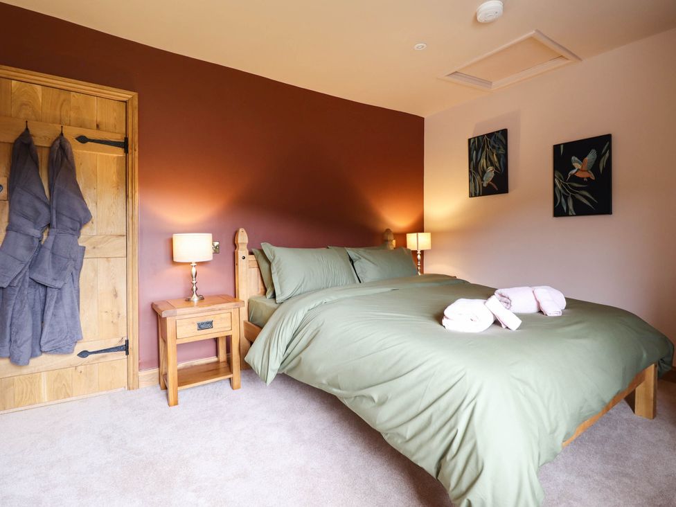 A bedroom with a bed and bedside table at Bridge Farm Pontyblew near Chirk