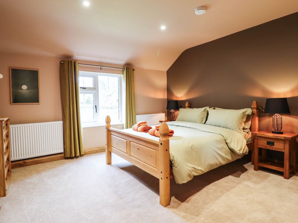 A bedroom with a bed and bedside tables at Bridge Farm in Pontyblew near Chirk