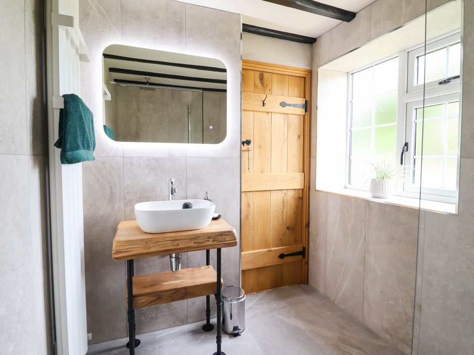 A bathroom with a sink and mirror at Bridge Farm Pontyblew near Chirk