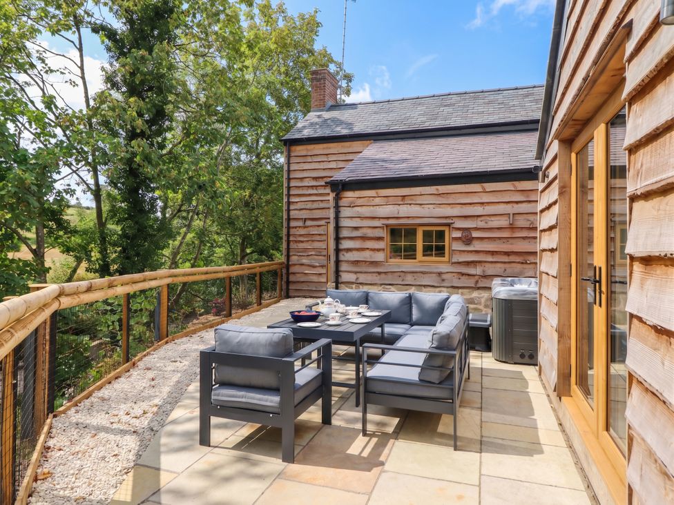 An outdoor seating area with a sofa and table at Bridge Farm in Pontyblew near Chirk