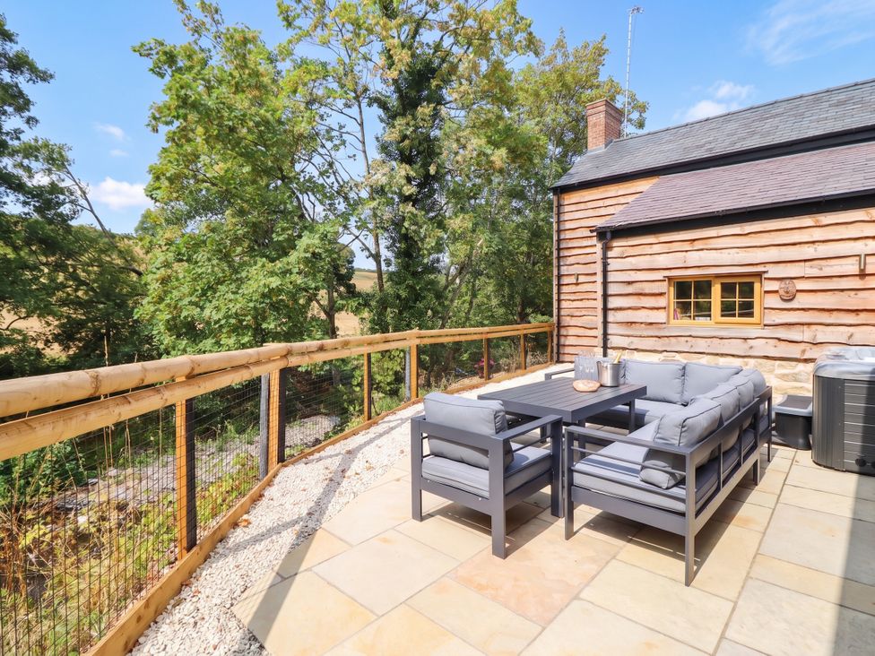 An outdoor seating area with a table at Bridge Farm Pontyblew near Chirk