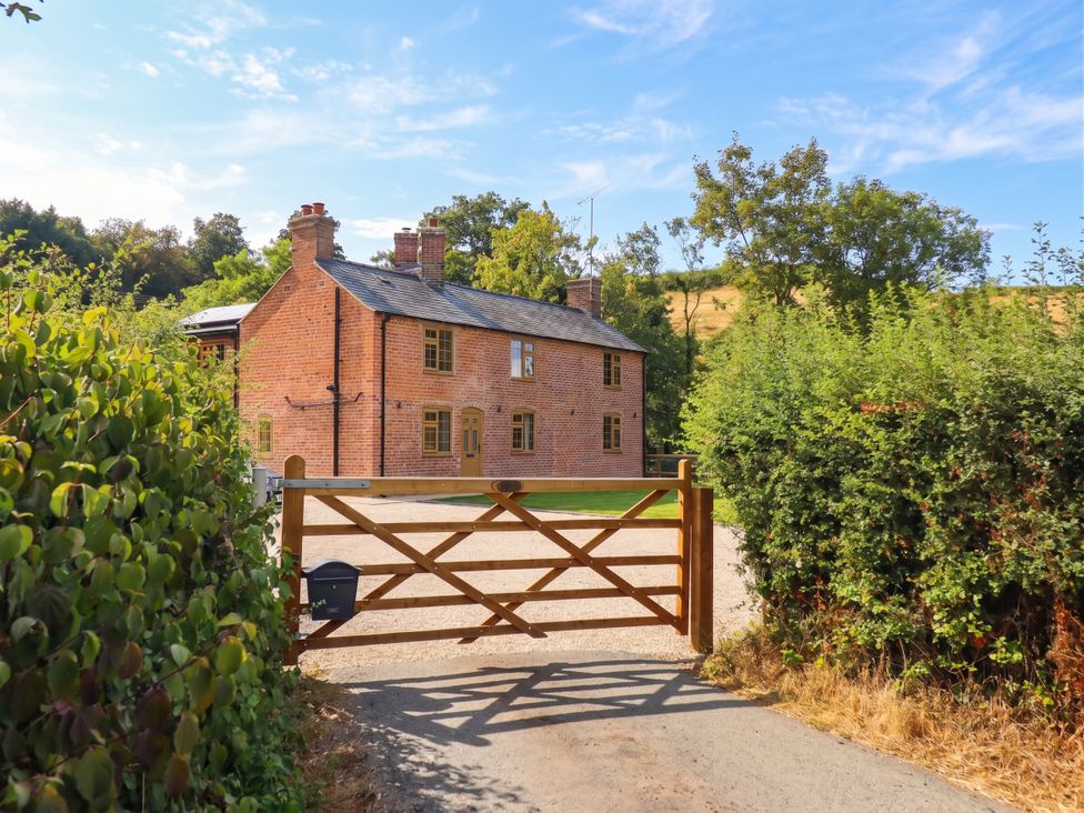 A house with a gate and driveway at Bridge Farm Pontyblew near Chirk