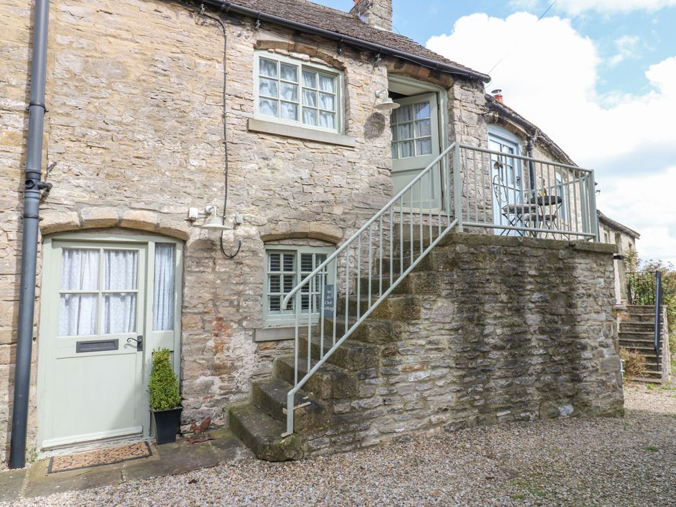 An entrance with stairs leading to a balcony at In & Out Cottage in Leyburn