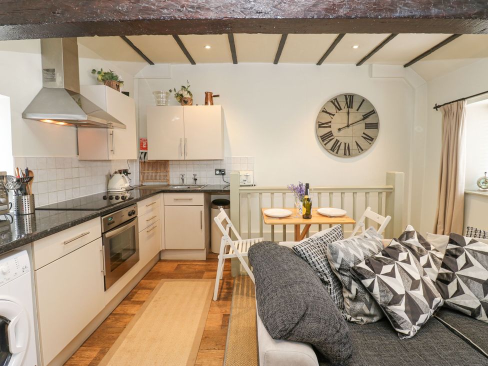 A kitchen with countertop and seating area at In & Out Cottage Leyburn