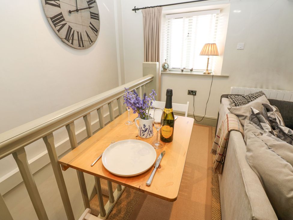 A dining area with a table set for two at In & Out Cottage Leyburn