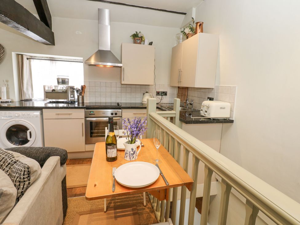 A kitchen with a table and chairs at In & Out Cottage Leyburn