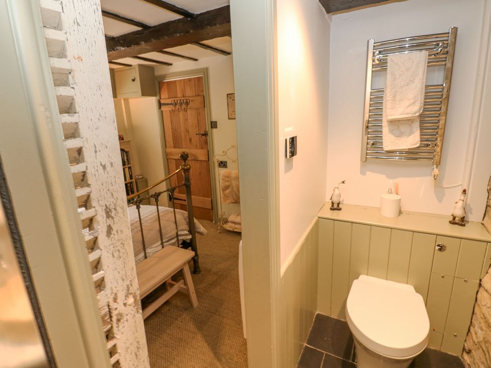 A bathroom with a toilet and towel rail at In & Out Cottage in Leyburn