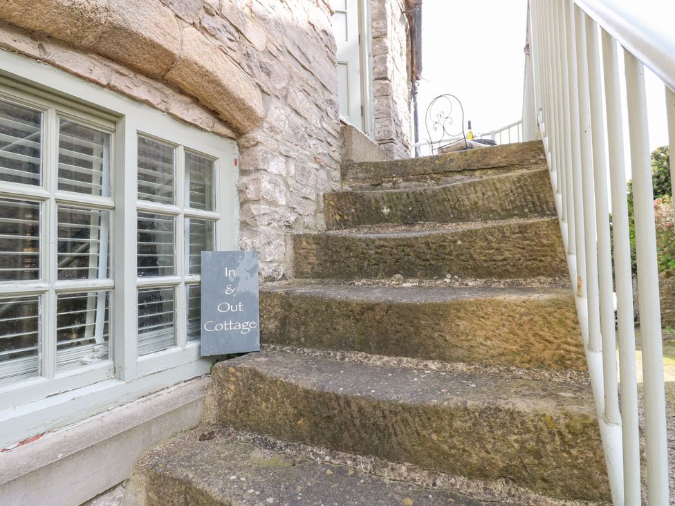 Stone steps leading to a sign at In & Out Cottage Leyburn