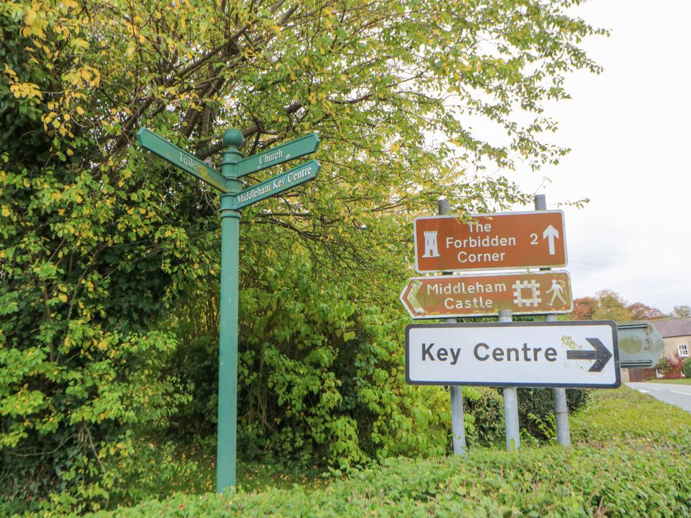 A signpost directing to local attractions at In & Out Cottage Leyburn