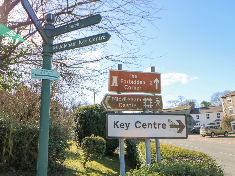 A signpost indicating directions to various locations in Middleham