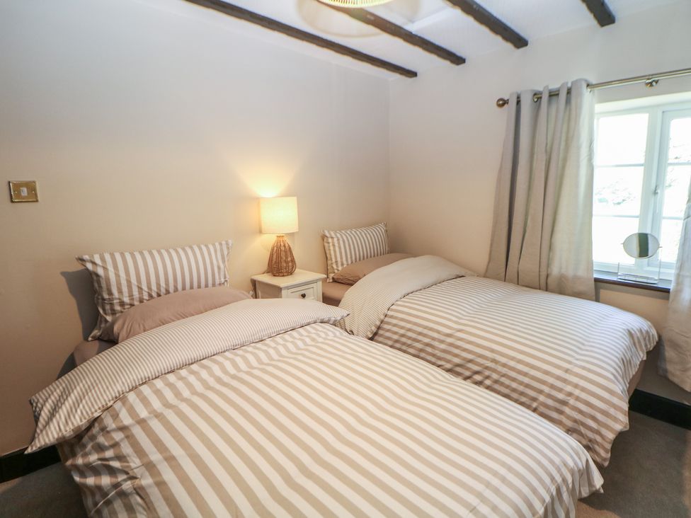 A bedroom with two beds and a window at Pine Cottage in 