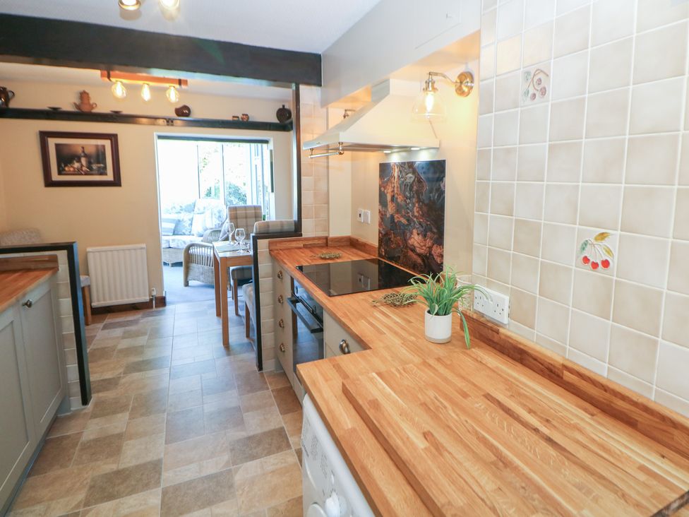 A kitchen with a countertop and a stove at Pine Cottage