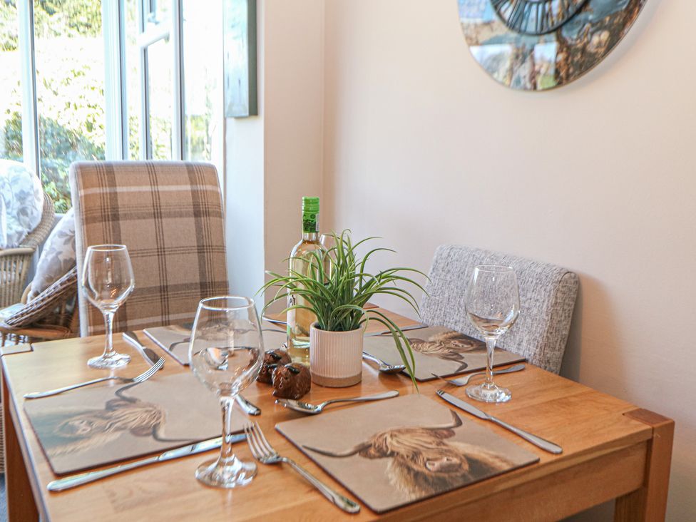 A dining room with a table set for two at Pine Cottage 