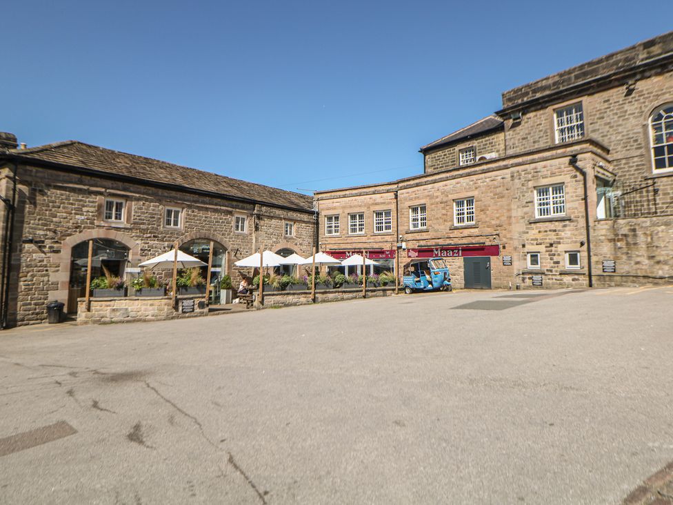 An outdoor area with tables and umbrellas at Pine Cottage