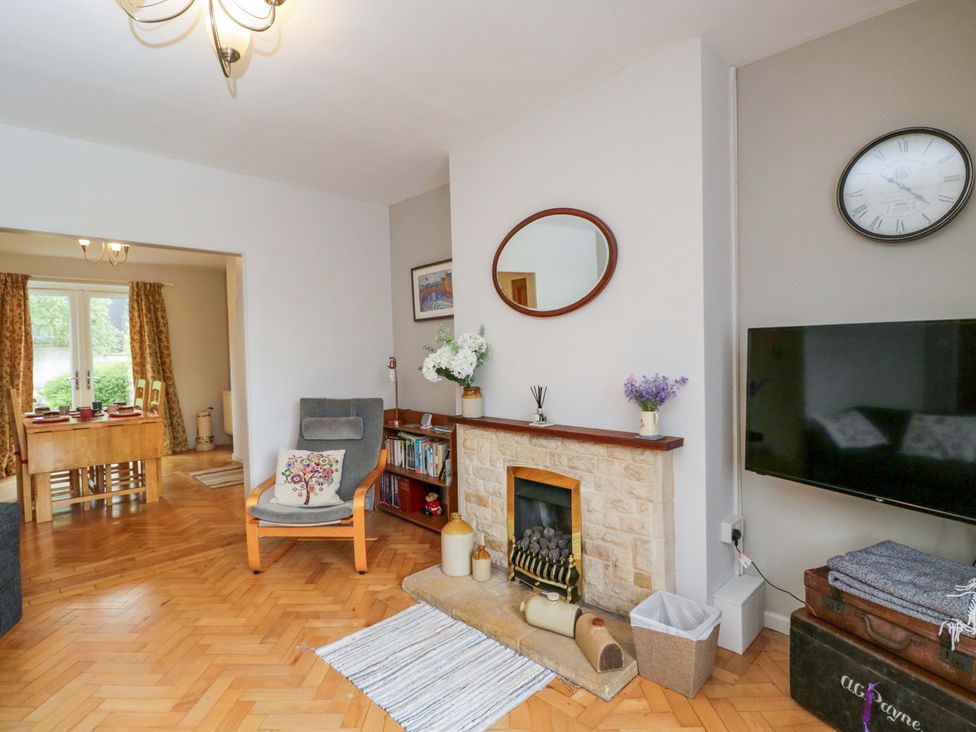 A living room with a fireplace and a sofa at Highbury in Bath