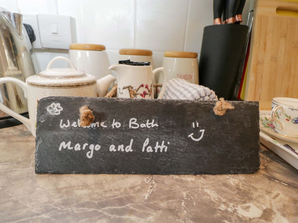 A slate sign with welcome message in a kitchen at Highbury in Bath