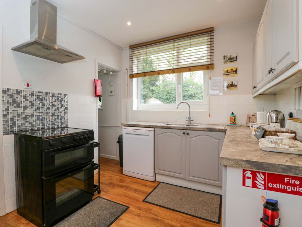 A kitchen with a stove and dishwasher at Highbury in Bath