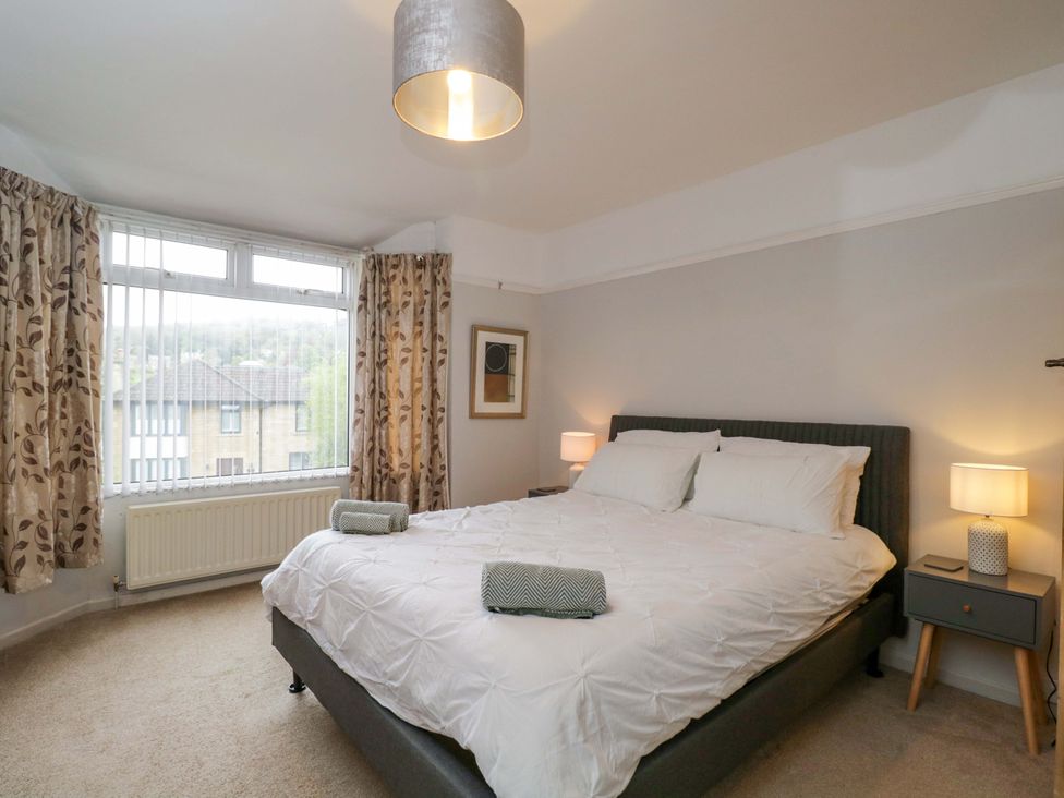 A bedroom with a bed and lamps at Highbury in Bath