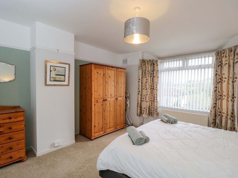 A bedroom with a bed and wooden furniture at Highbury in Bath