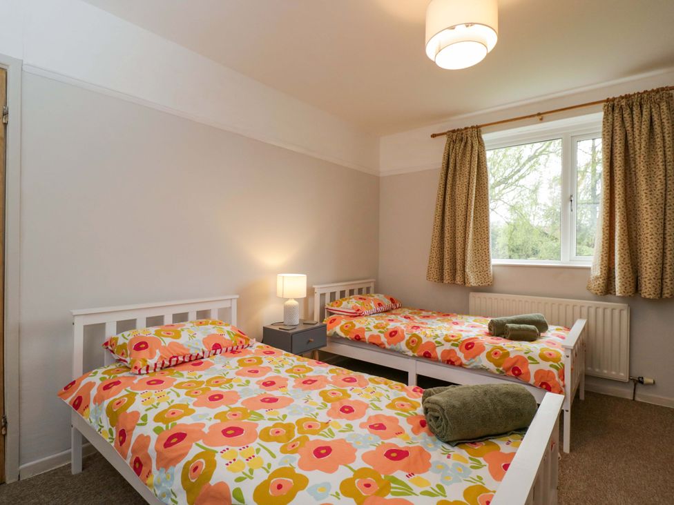 A bedroom with two beds and a lamp at Highbury in Bath
