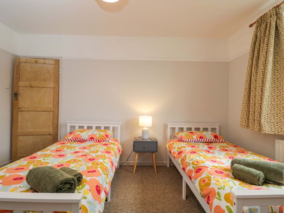 A bedroom with two beds and a nightstand at Highbury in Bath