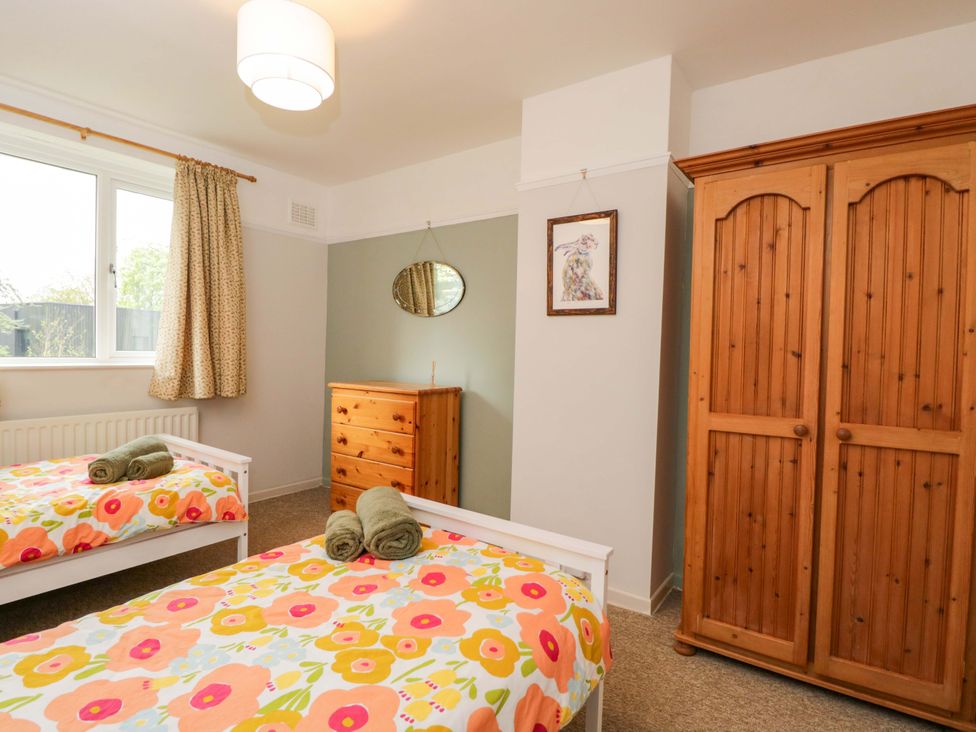 A bedroom with two beds and furniture at Highbury in Bath