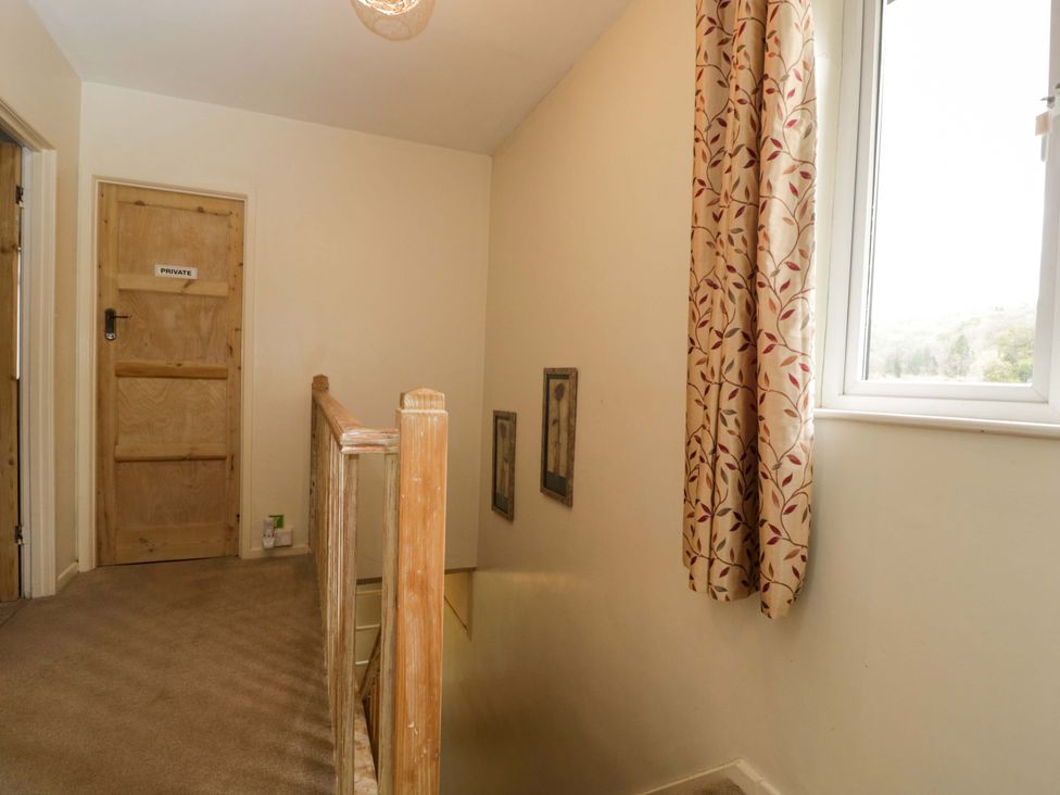 A hallway with a door and staircase at Highbury in Bath
