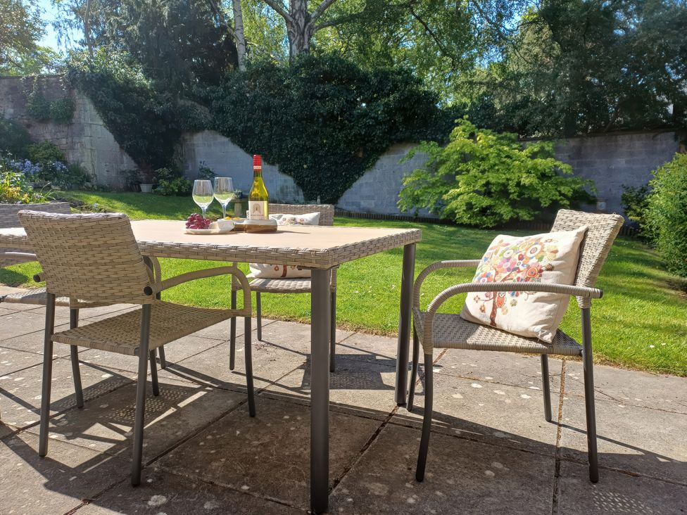 A garden setting with a table and chairs at Highbury in Bath