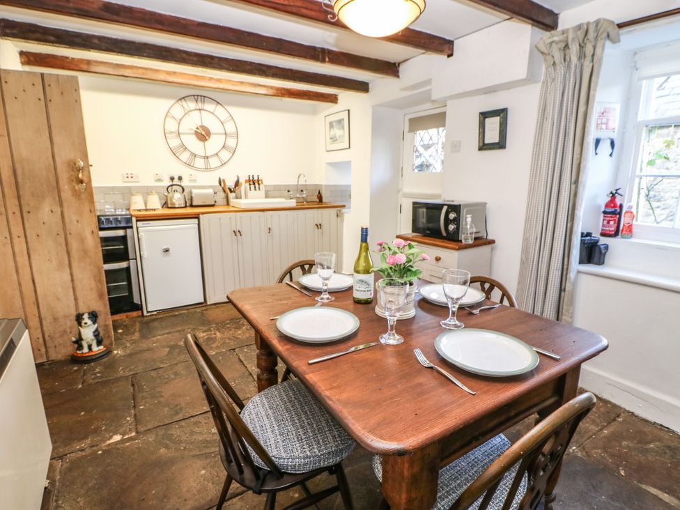A kitchen with a table and chairs at Englewood Cottage in Hexham