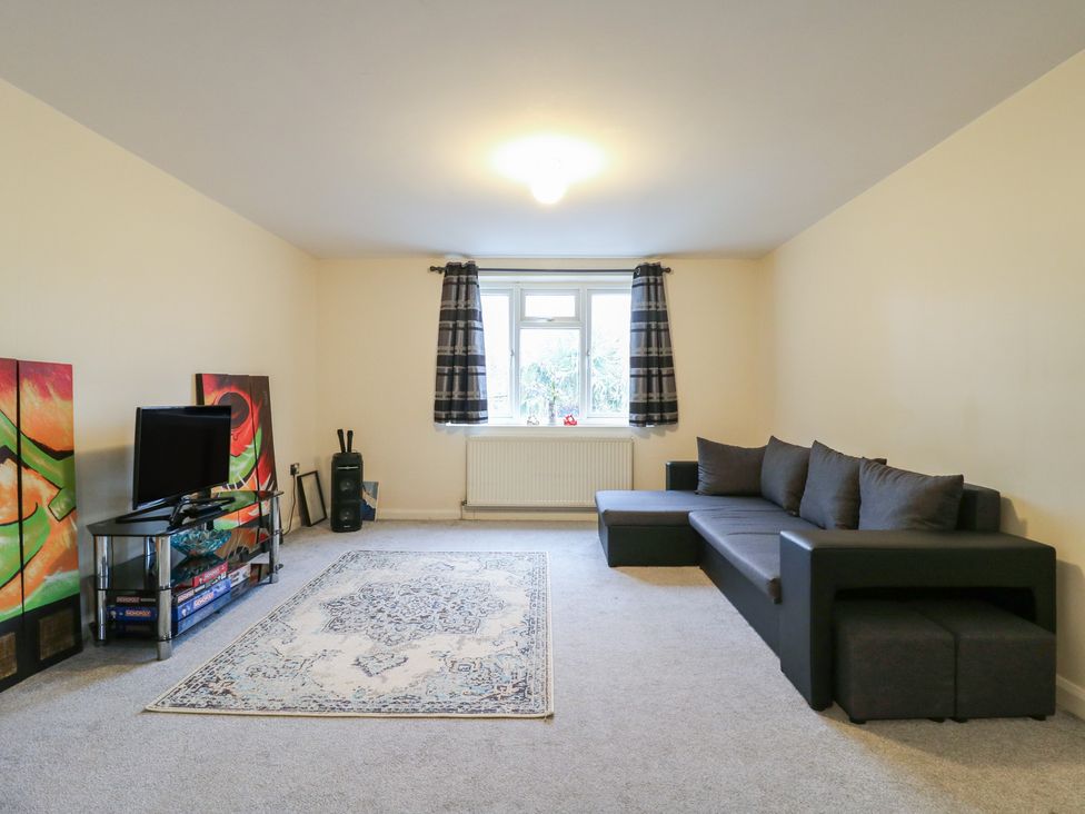 A living room with a sofa and television at Peckhamsbest Suite in London