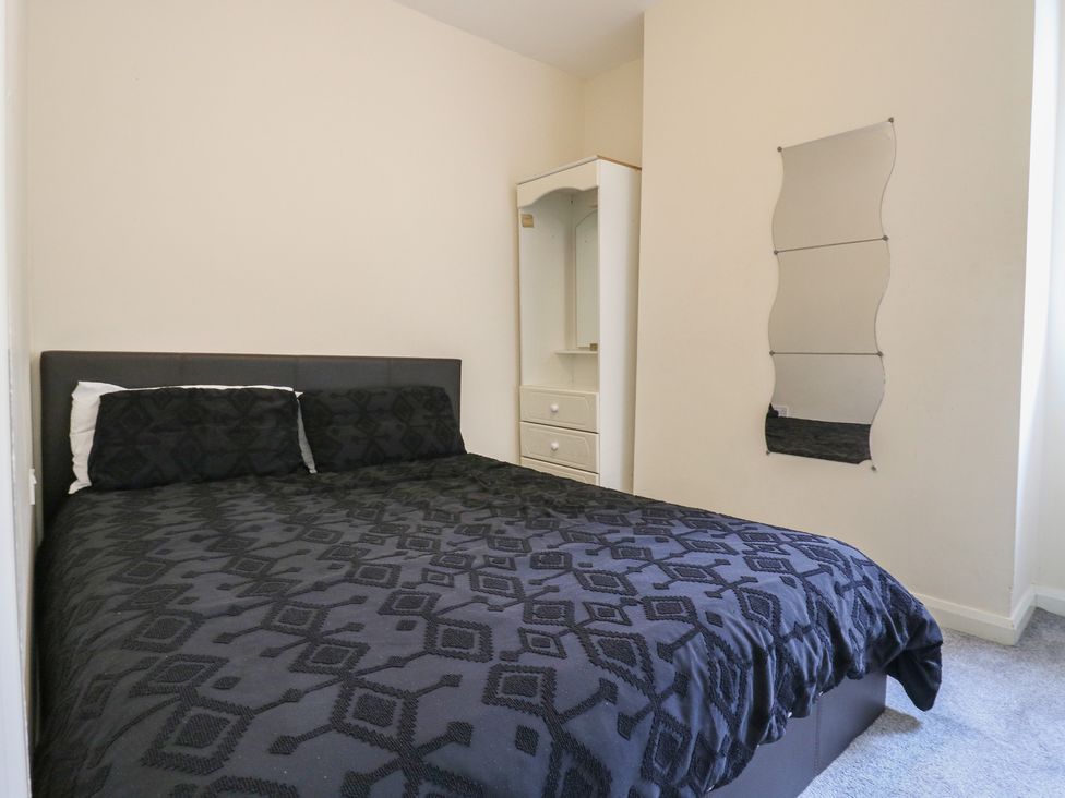 A bedroom with a bed and dresser at Peckhamsbest Suite in London