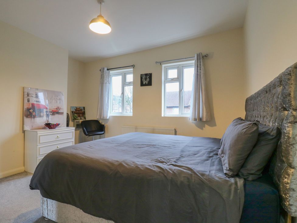 A bedroom with a bed and artwork at Peckhamsbest Suite in London