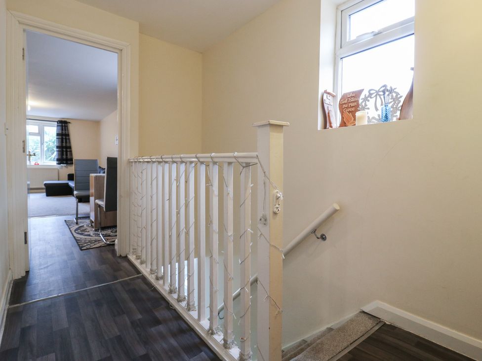 A hallway with a staircase and access to a living area at Peckhamsbest Suite in London