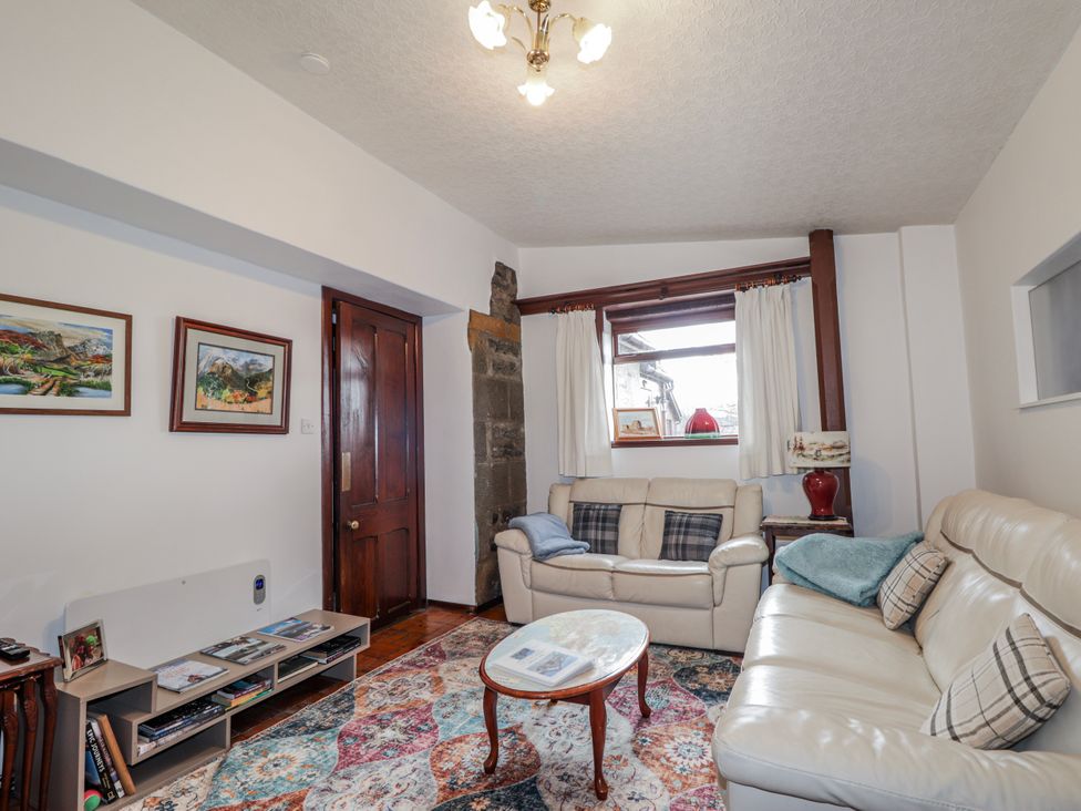 A living room with a sofa and coffee table at Islay Cottage in Kincraig