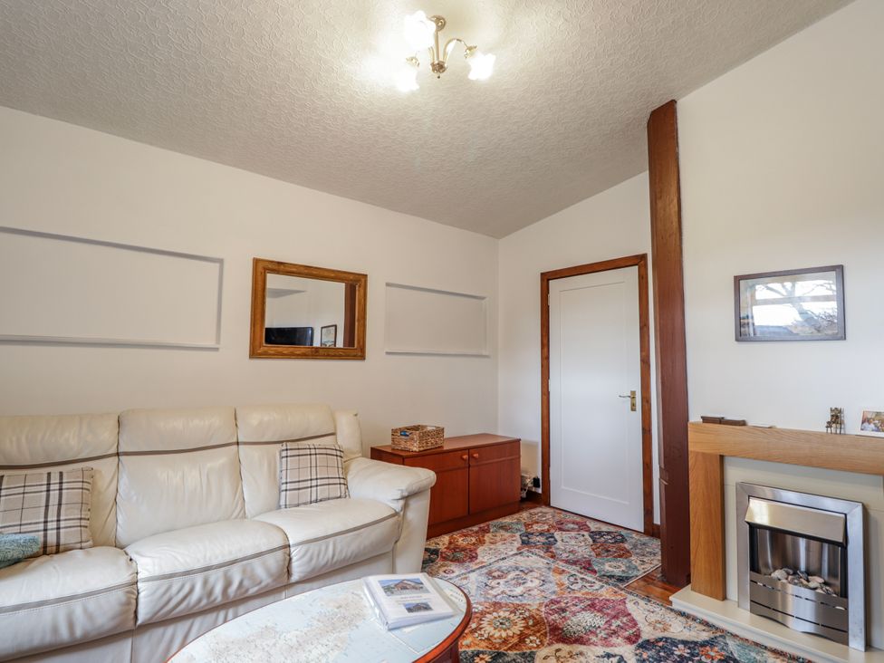 A living room with a sofa and coffee table at Islay Cottage Kincraig