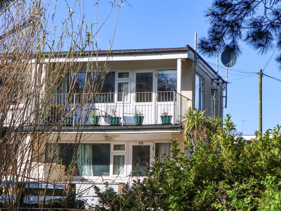 A building with balcony and plants at Flat 1 Lee Cliff Park Dawlish Warren