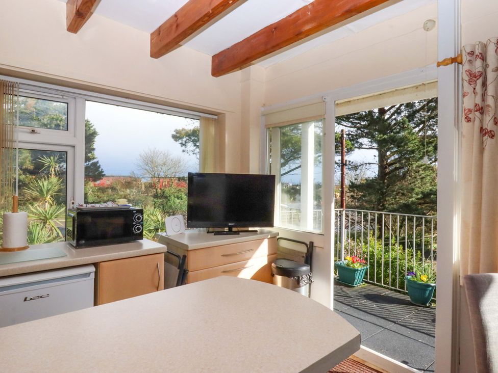 A kitchen with a refrigerator and microwave at Flat 1 Lee Cliff Park, Dawlish Warren