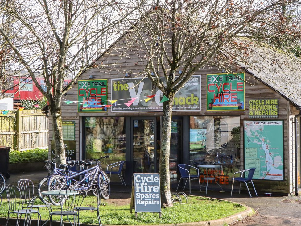 A cycle hire shop with bicycles and outdoor seating at Flat 1 Lee Cliff Park Dawlish Warren