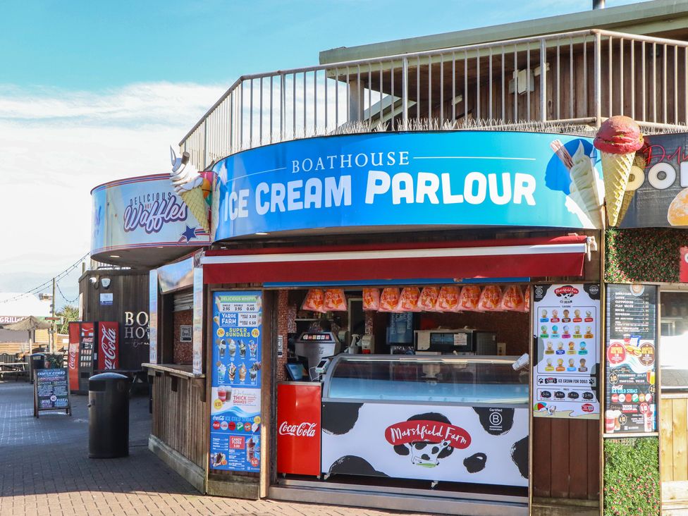 An ice cream parlour sign with menus and a counter at Boathouse in Dawlish Warren
