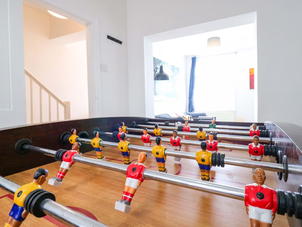 A foosball table with players in a games room at 7 Athol Terrace
