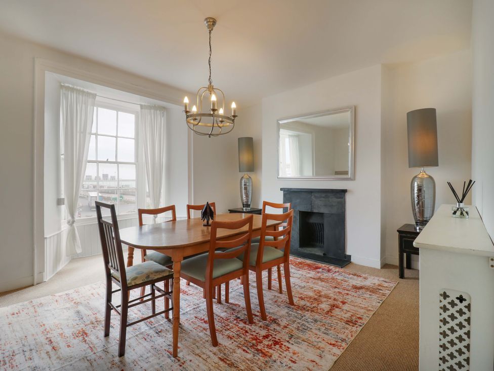A dining room with a table and chairs at 7 Athol Terrace