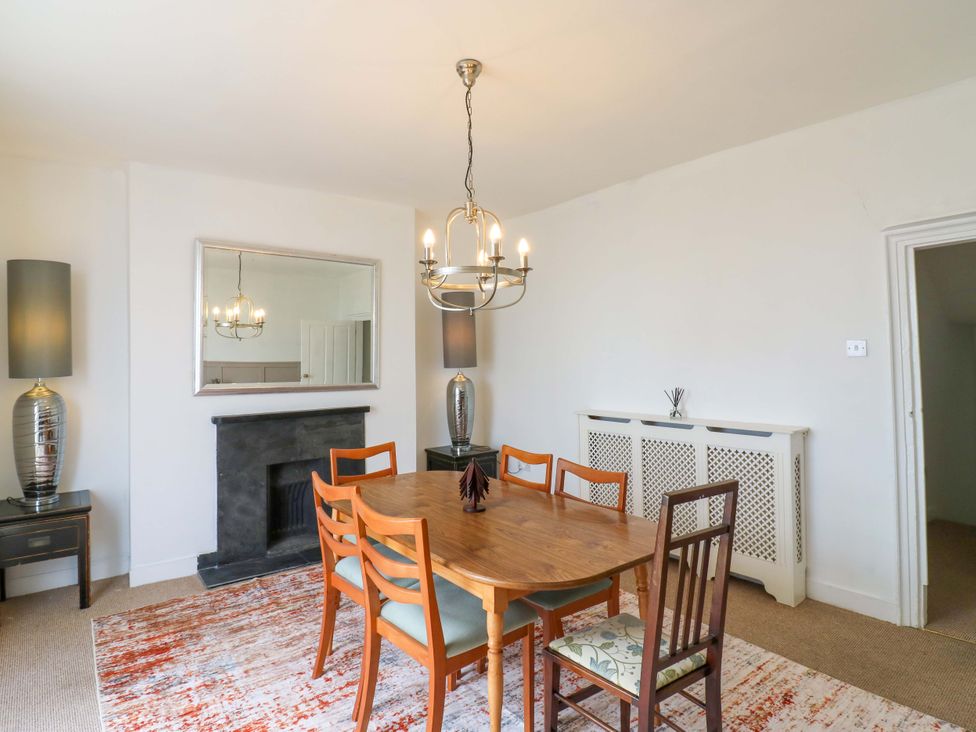 A dining room with a table and chairs at 7 Athol Terrace